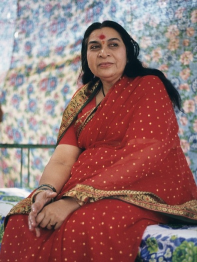 Shri Mataji Nirmala Devi, smiling to the right side, in turquoise-blue sari