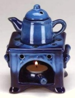 blue ceramic aromatherapy diffuser, teapot on stand and tee light below