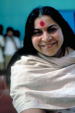 Shri Mataji smiling, head, right shoulder and arm, grey shawl
